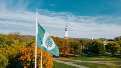 The Dartmouth flag flies in front of Baker Tower.