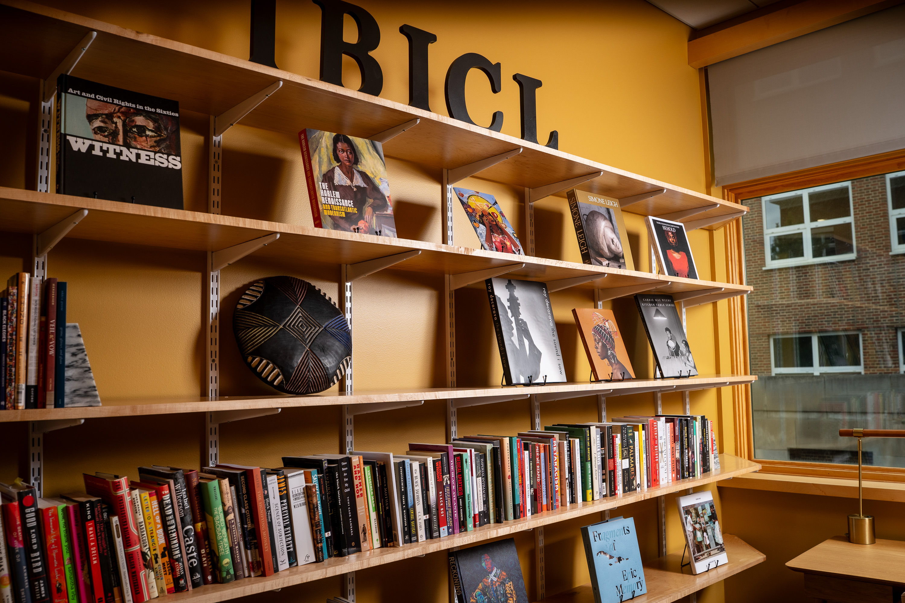A bookshelf with the letters IBICL placed on top