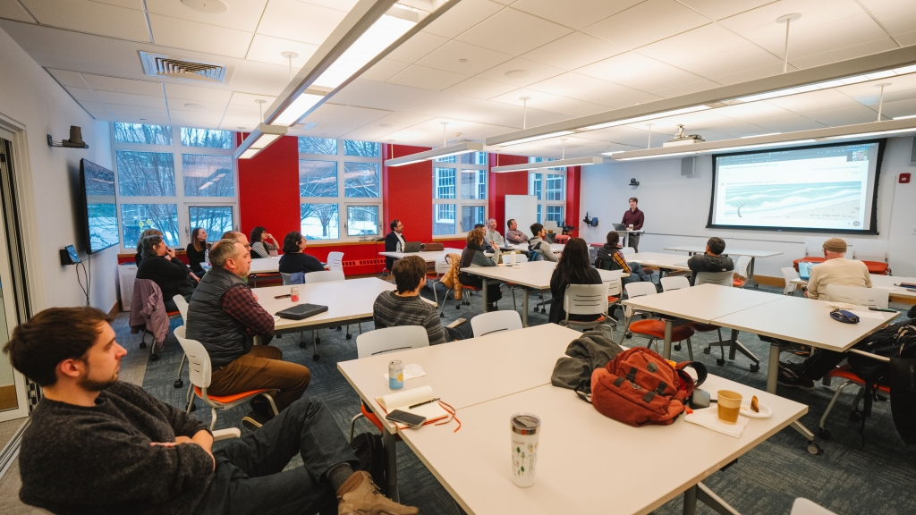 Faculty members at tables in a classroom