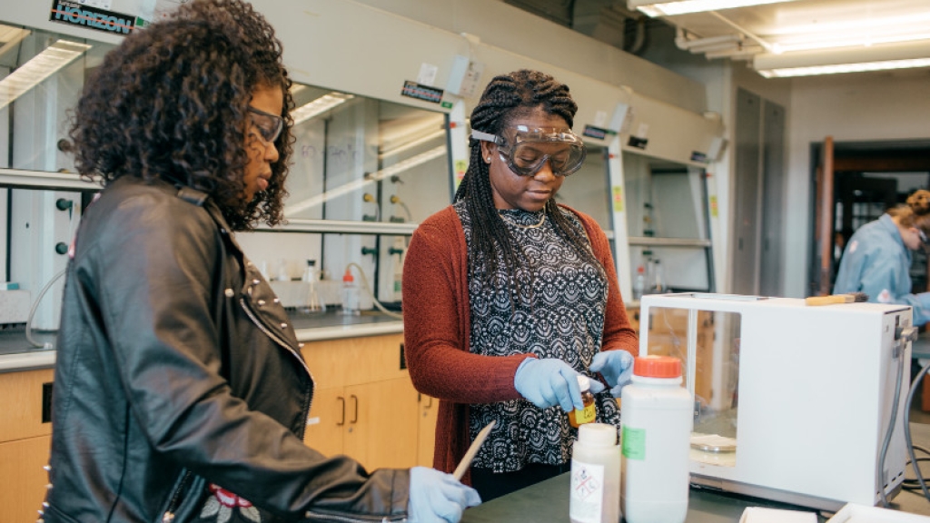Two students work in a science lab.