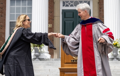 Matthew Slaughter fist bumping a Tuck graduate